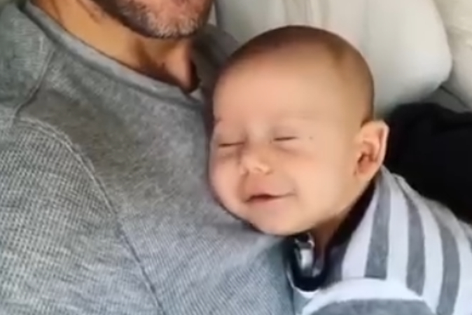 Why are babies smiling while sleeping
